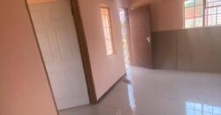 Residential fenced plot with a newly built 2bedrooms bachelor pad holding a title deed in Gakuto village