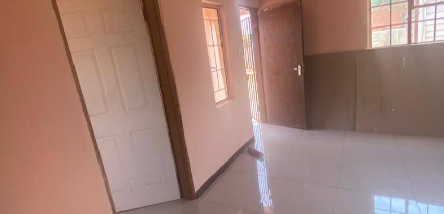 Residential fenced plot with a newly built 2bedrooms bachelor pad holding a title deed in Gakuto village